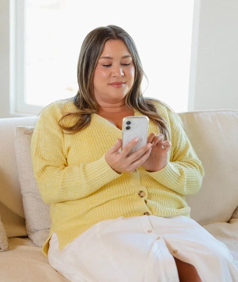 Member messaging her provider from the couch